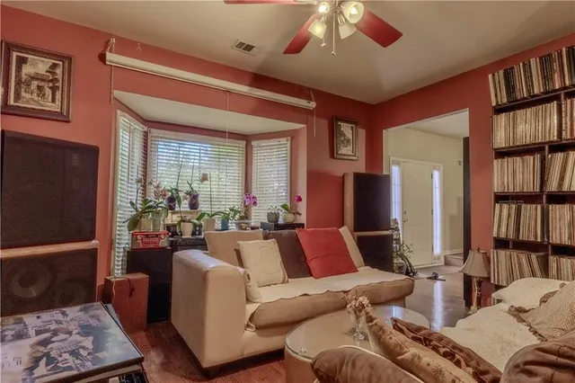 a living room with furniture and a book shelf