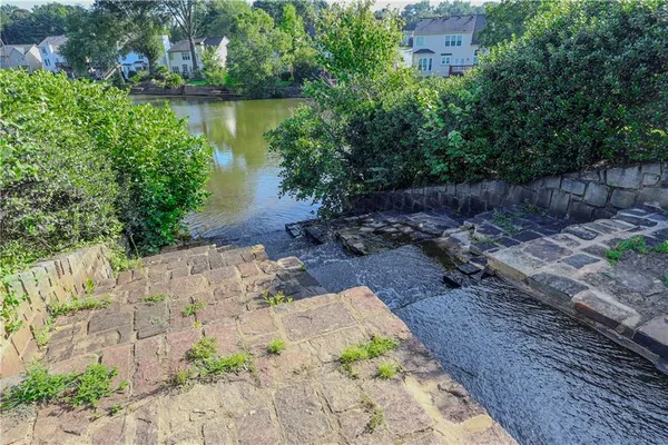 a view of a lake with a house in the background