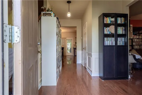 a view of a hallway with wooden floor and entryway