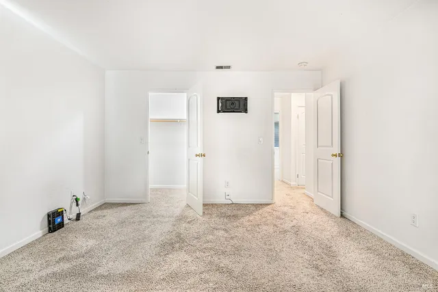a bathroom with a granite countertop toilet sink and mirror