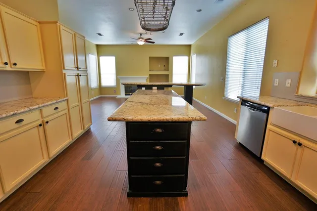 a kitchen with stainless steel appliances granite countertop a sink stove and cabinets
