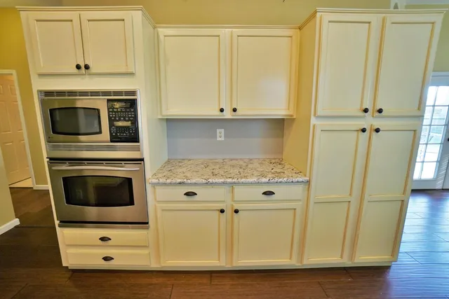 a kitchen with stainless steel appliances granite countertop a sink and cabinets