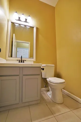 a view of a hallway with wooden floor and chandelier