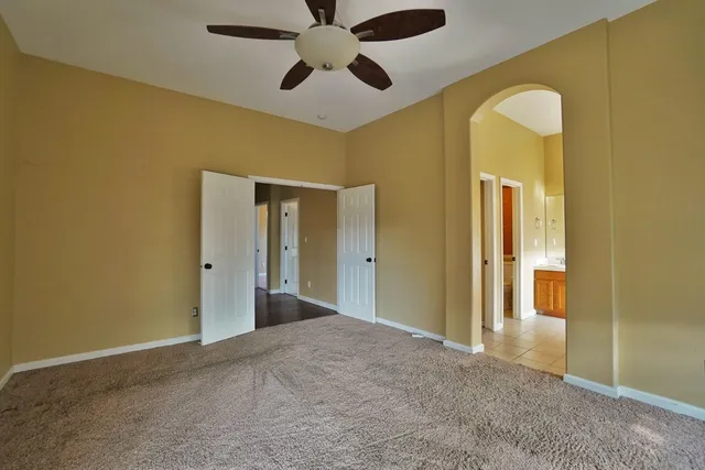 a view of a patio with table and chairs and floor to ceiling window