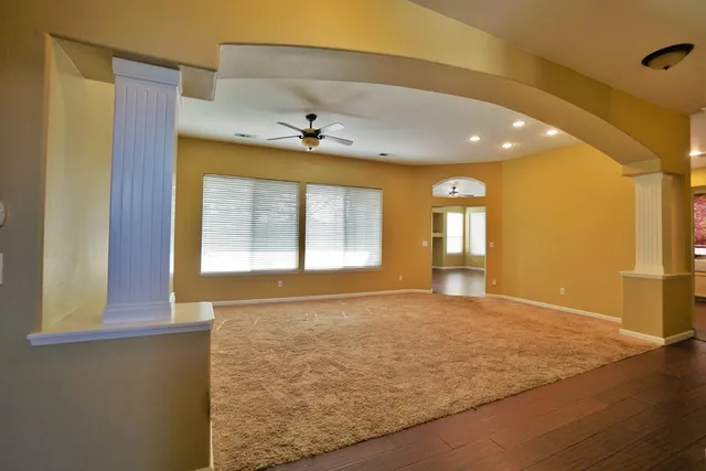 an empty room with a empty space and a ceiling fan