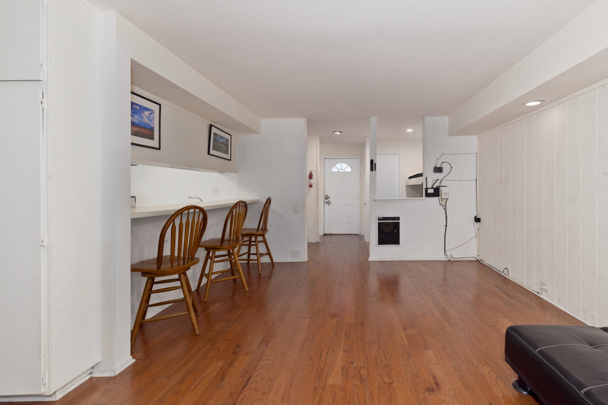 25 Lee Road, Unit 103 Mammoth Lakes, CA 93546 - Photo 11 of 29 Expansive room featuring rich wood-finish flooring, a breakfast bar with countertop space, and recessed lighting