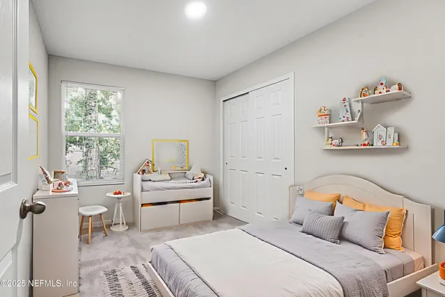 a bedroom with a bed and a table