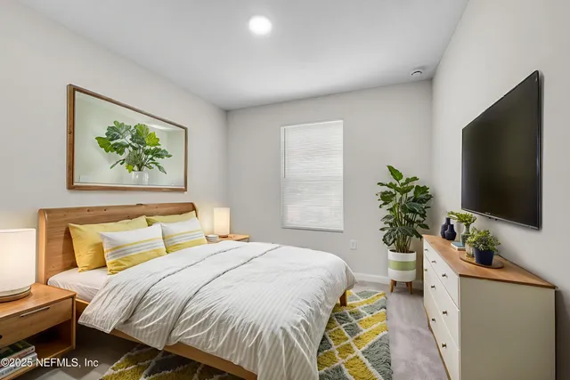 a bedroom with a bed and a flat screen tv