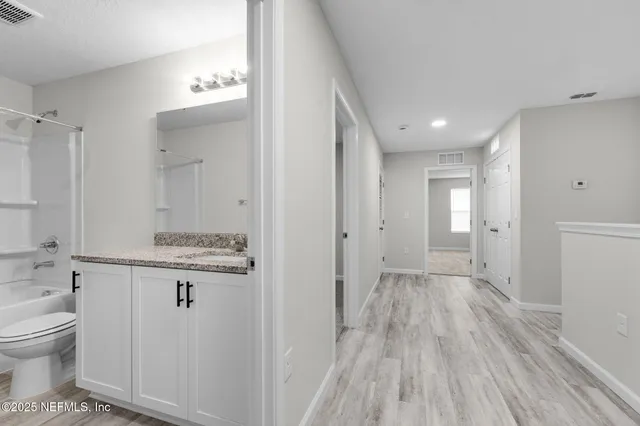 a view of bathroom with a toilet sink and mirror