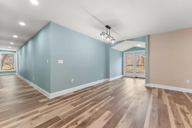 a view of a room with wooden floor and staircase