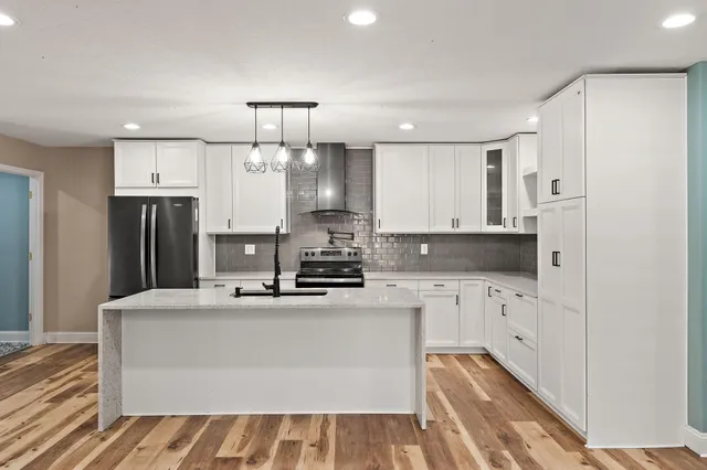 a kitchen with stainless steel appliances a refrigerator sink and stove
