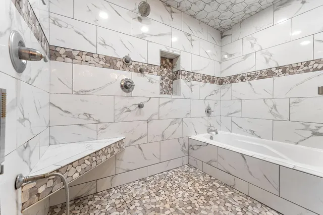 a bathroom with a bathtub and shower