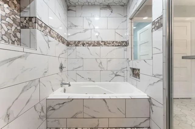 a bathroom with a bathtub and shower