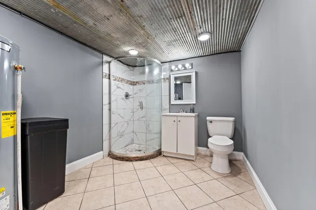 a bathroom with a toilet and a shower