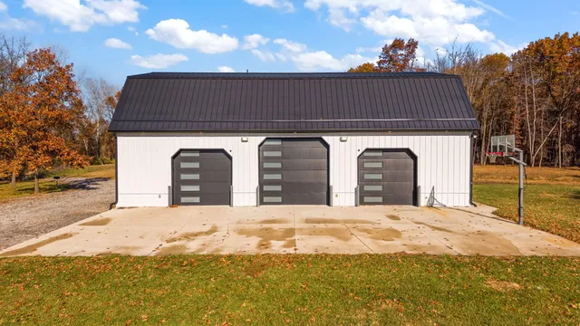 a front view of a house with yard and trees