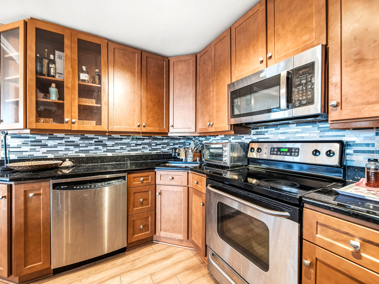 5455 North Sheridan Road, Unit 1404 Chicago, IL 60640 - Photo 7 of 24 a kitchen with stainless steel appliances granite countertop a stove and a microwave