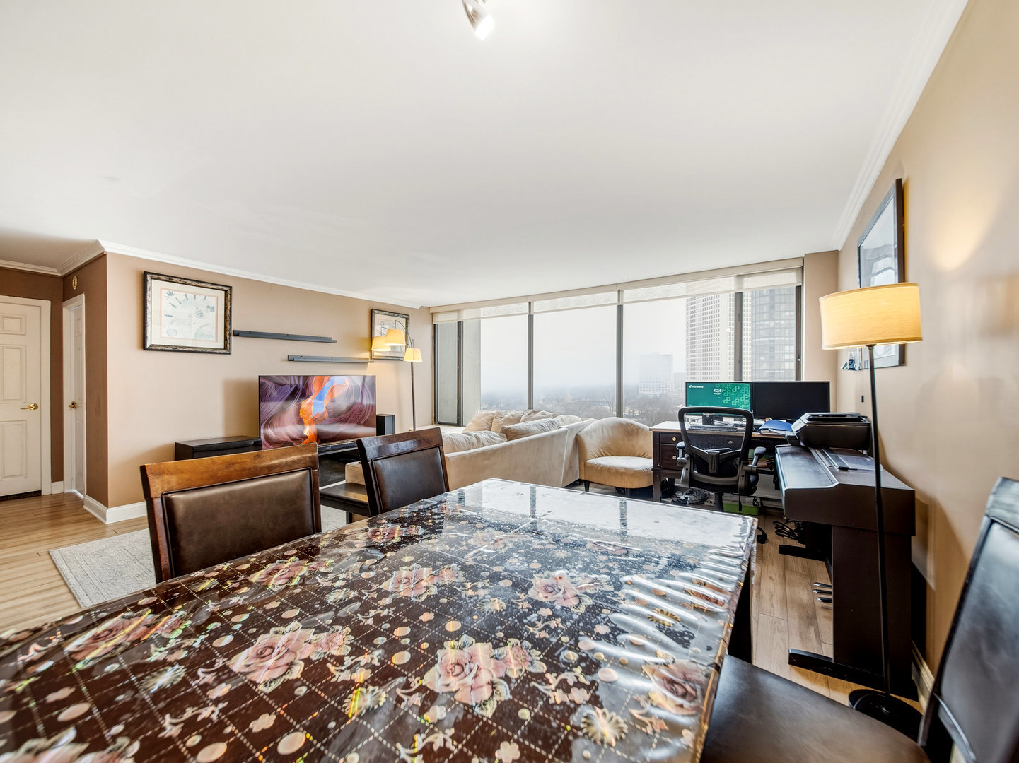 5455 North Sheridan Road, Unit 1404 Chicago, IL 60640 - Photo 9 of 24 a living room with furniture a lamp and a window