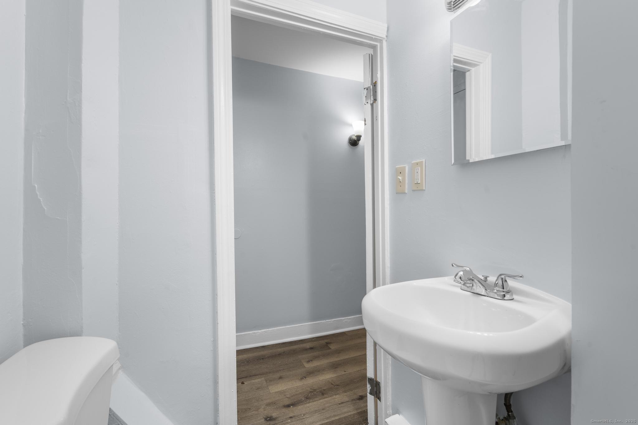 156 Orange Street Waterbury, CT 06704 - Photo 11 of 32 a bathroom with a sink a toilet and mirror