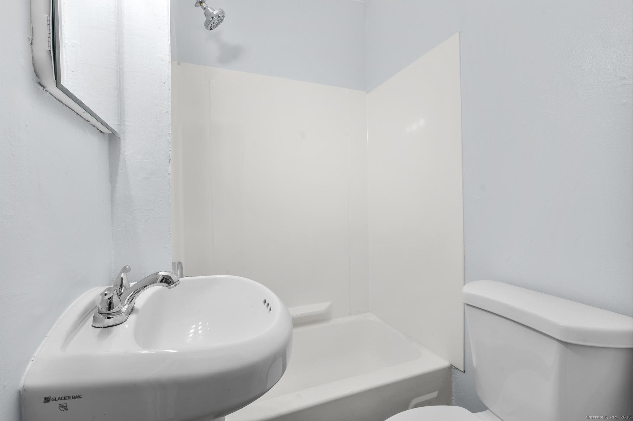 156 Orange Street Waterbury, CT 06704 - Photo 12 of 32 a bathroom with a sink and a toilet