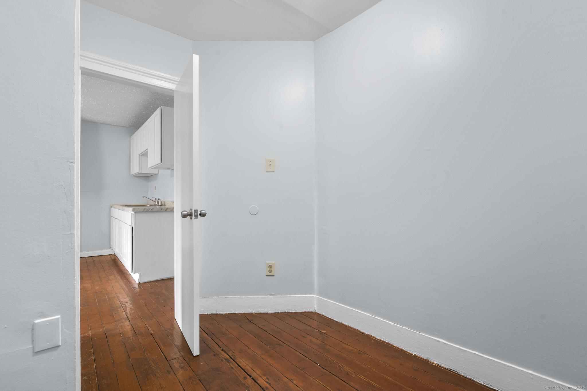 156 Orange Street Waterbury, CT 06704 - Photo 13 of 32 a view of empty room with wooden floor