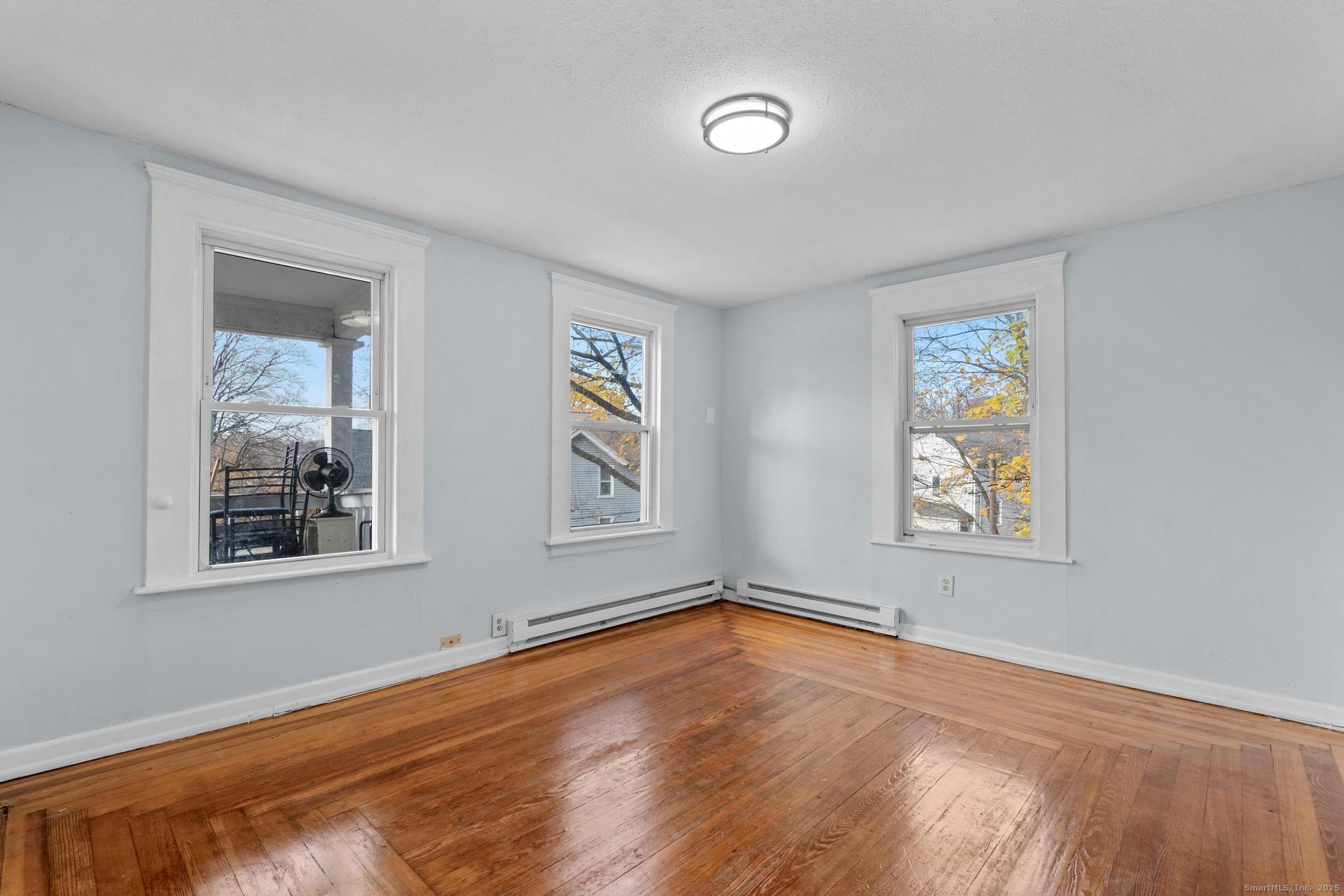156 Orange Street Waterbury, CT 06704 - Photo 2 of 32 a view of empty room with window and wooden floor