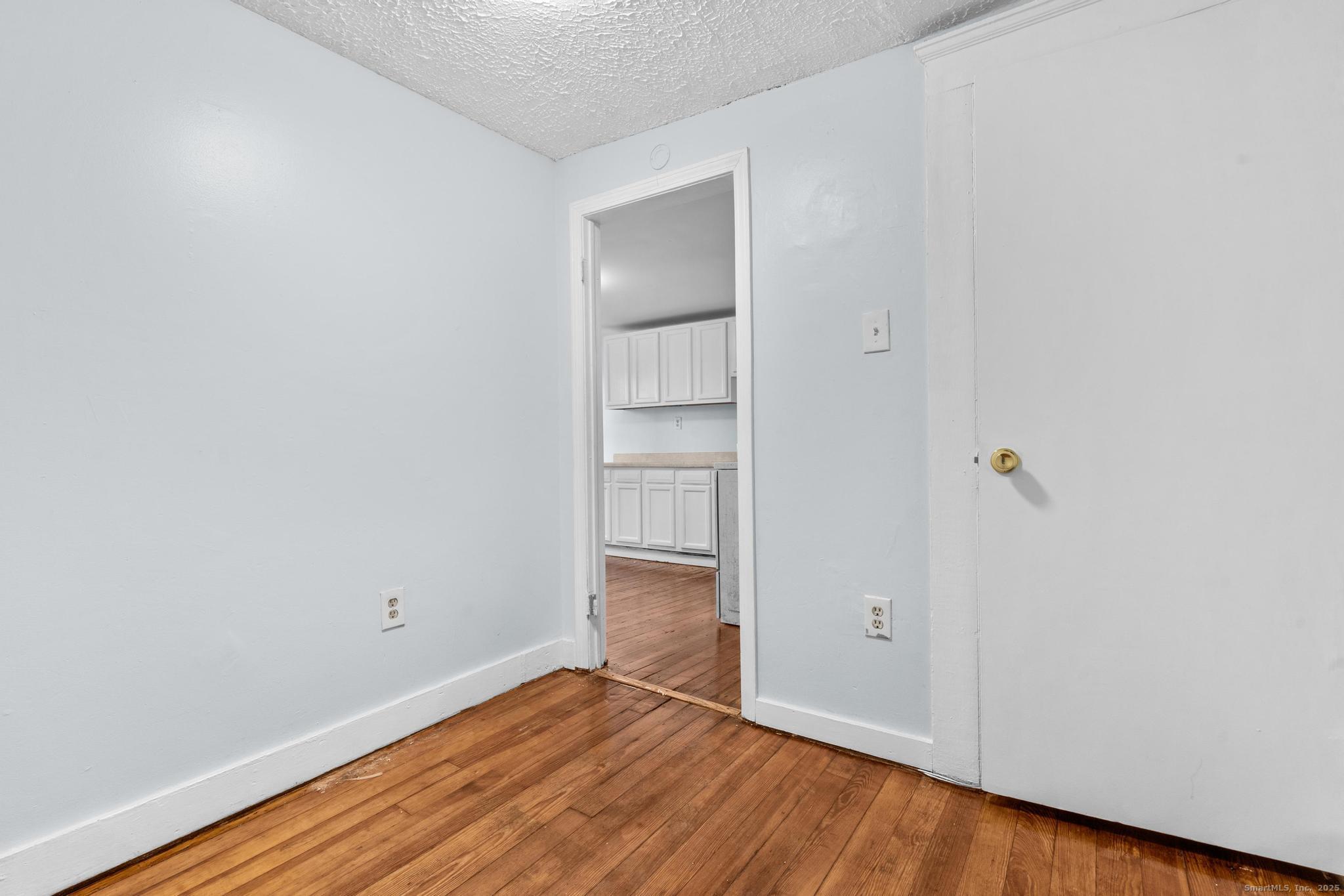 156 Orange Street Waterbury, CT 06704 - Photo 24 of 32 a view of an empty room with wooden floor and closet