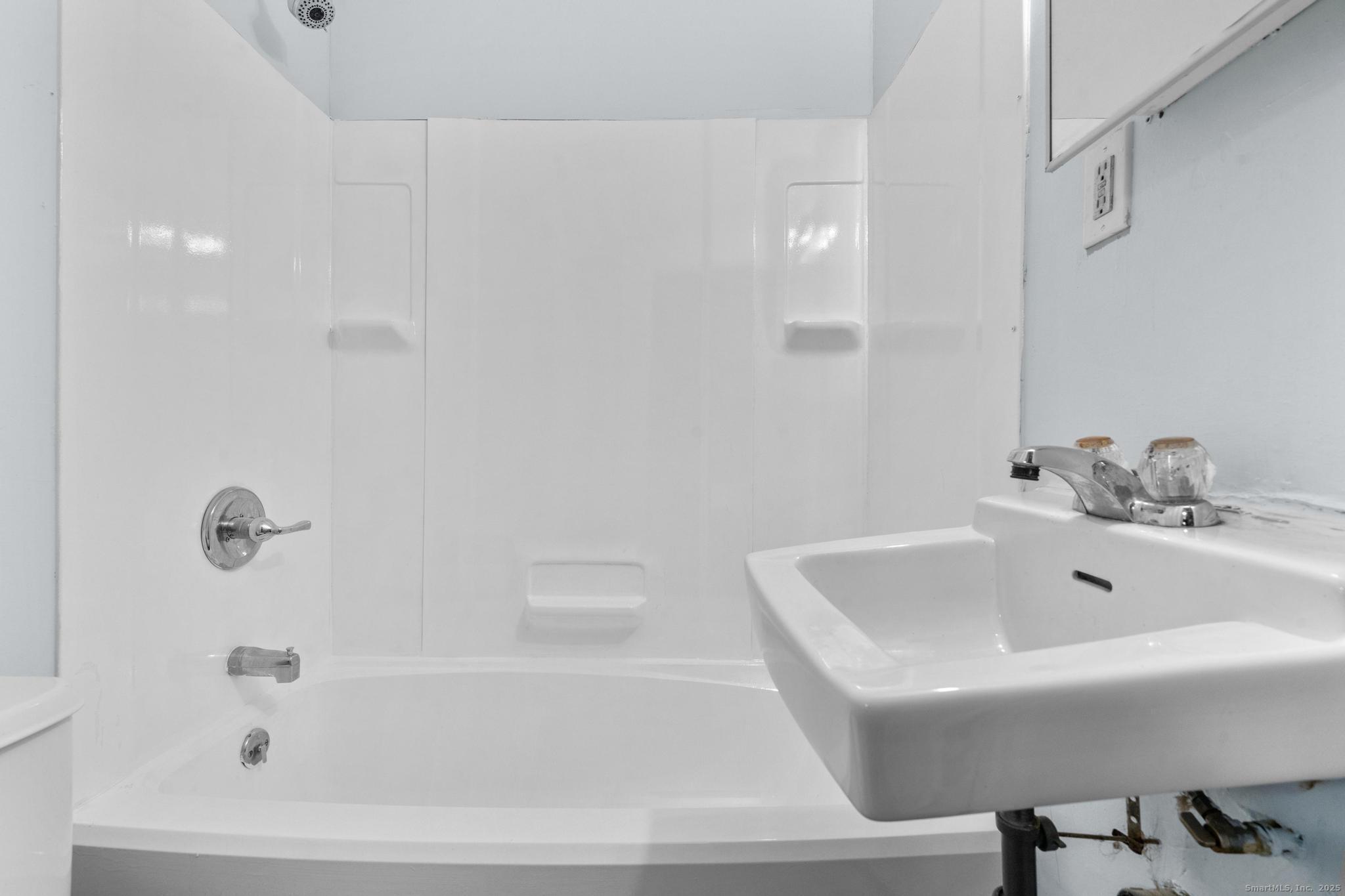 156 Orange Street Waterbury, CT 06704 - Photo 25 of 32 a white bath tub sitting next to a white sink
