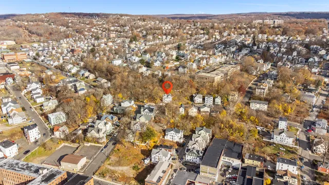 an aerial view of residential houses with city view
