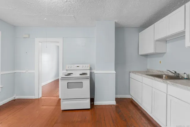 a kitchen with a sink cabinets and stainless steel appliances