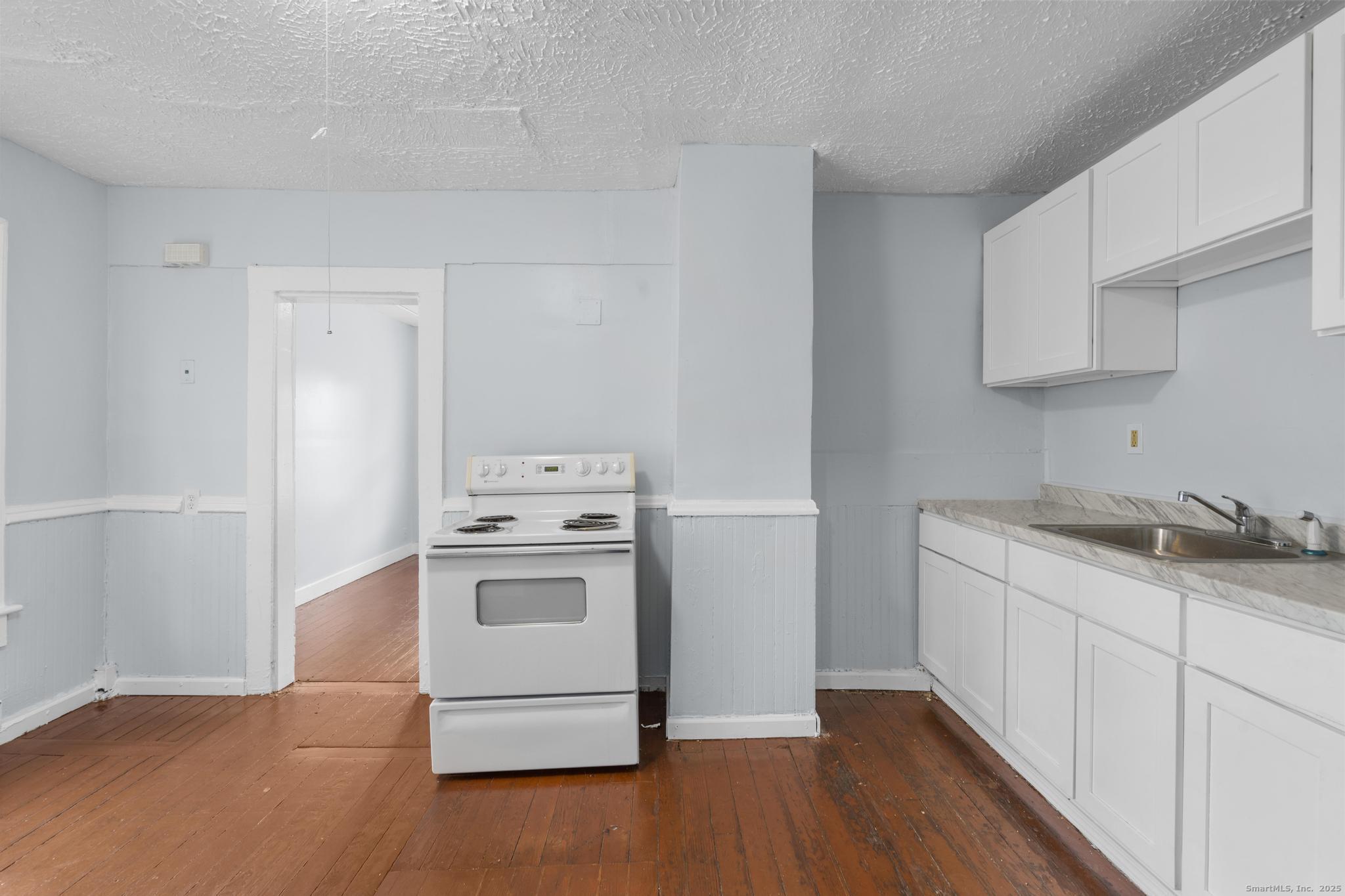 156 Orange Street Waterbury, CT 06704 - Photo 7 of 32 a kitchen with a sink cabinets and stainless steel appliances