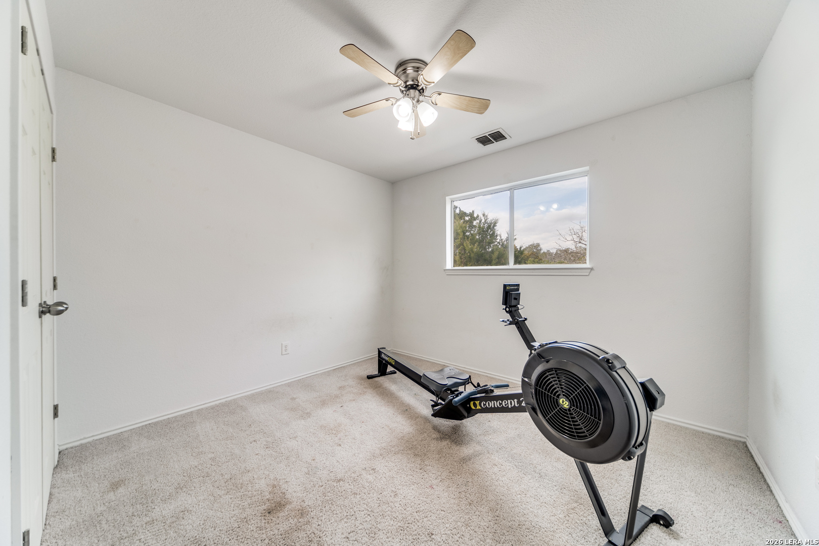 1145 Bob White Drive Spring Branch, TX 78070 - Photo 16 of 27 an empty room with windows and ceiling fan