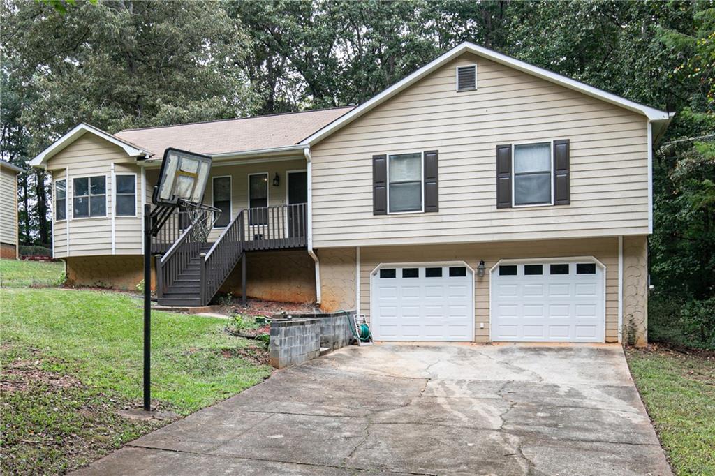 4804 Norma Lane Southwest Powder Springs, GA 30127 - Photo 1 of 1 a front view of a house with a yard