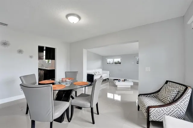 a dining room with furniture and wooden floor