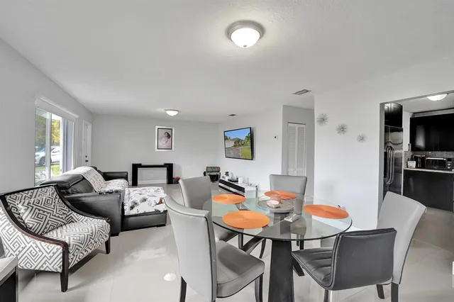 a dining room with furniture and window