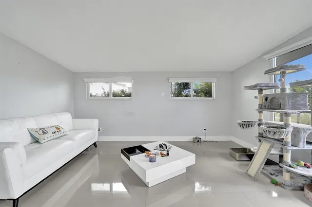 a living room with a baby crib and a couch