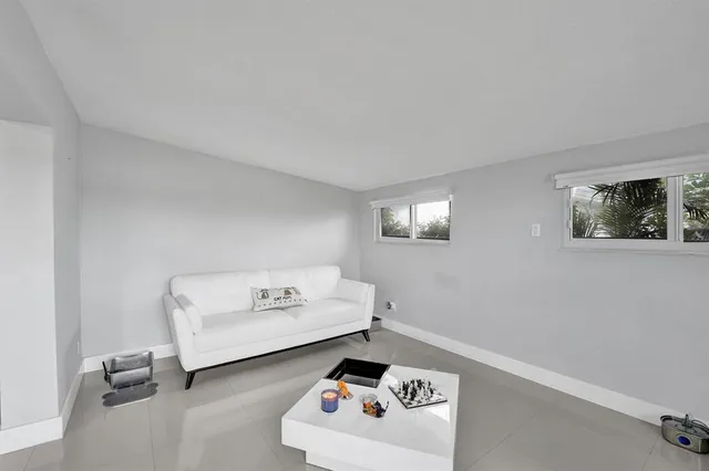 a living room with furniture and a dining table