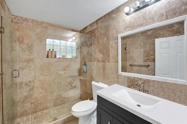 a bedroom with a bed and a night stand