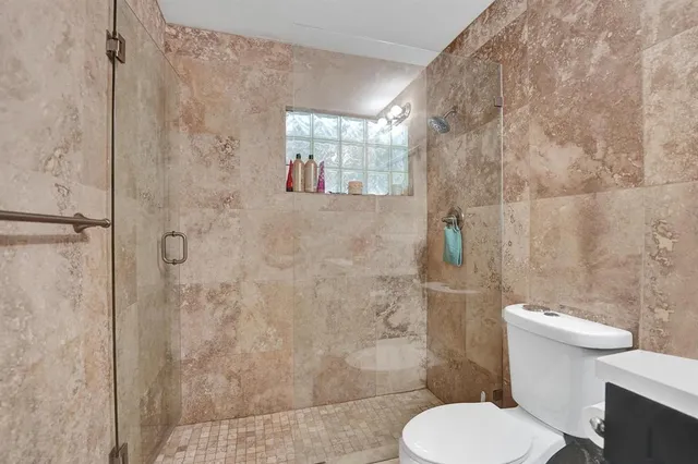 a bedroom with a bed and a view of kitchen