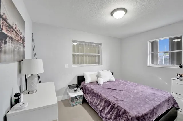 a bedroom with a bed and a desk