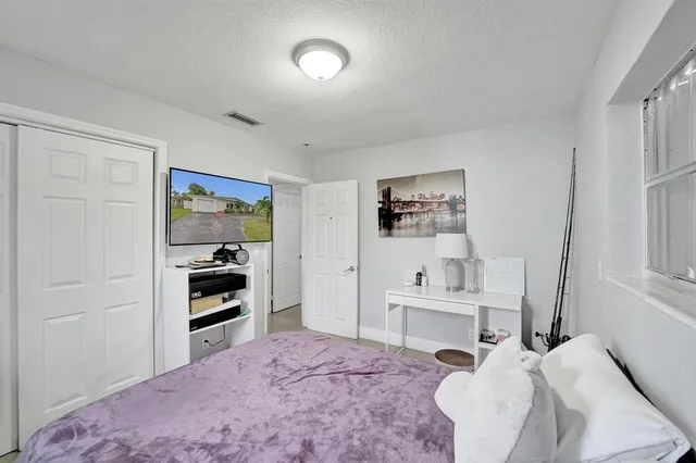 a bedroom with a bed and a mirror