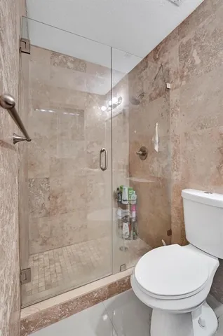 a kitchen with stainless steel appliances granite countertop a refrigerator a stove a sink and a microwave