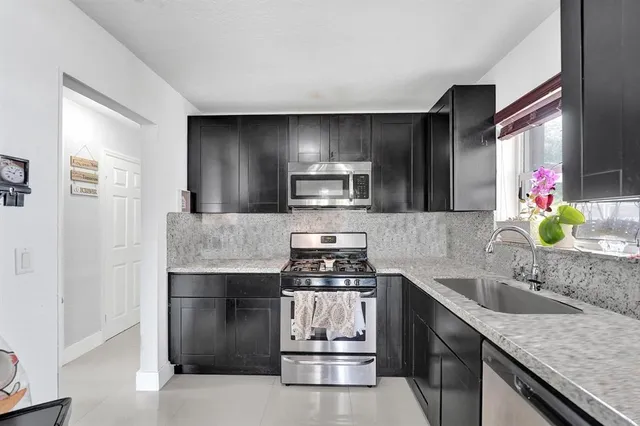 a view of a workspace with furniture and wooden floor