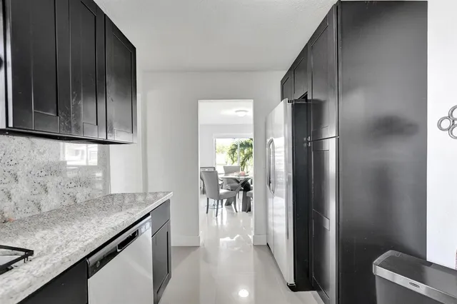 a view of a patio with table and chairs and potted plants