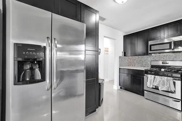 a view of a patio with table and chairs and potted plants