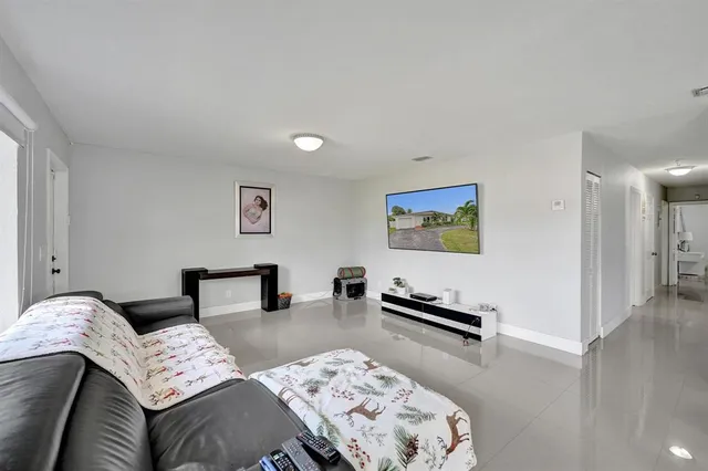 a white house that has a tree in front of it