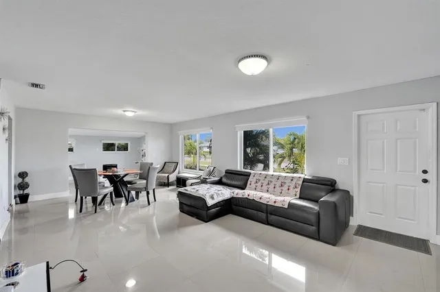 a living room with furniture potted plant and a window