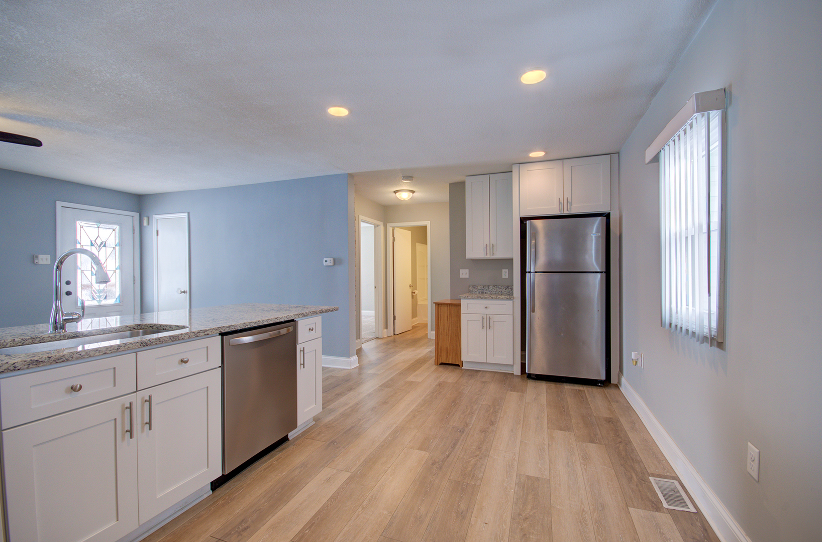 1168 South 5000W Road Kankakee, IL 60901 - Photo 10 of 30 a kitchen with stainless steel appliances a refrigerator and wooden floor