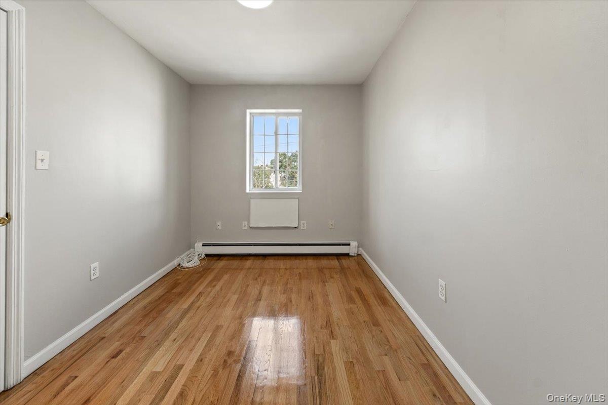 1309 Vreeland Avenue, Unit 2 Bronx, NY 10461 - Photo 6 of 13 a view of a room with wooden floor and window