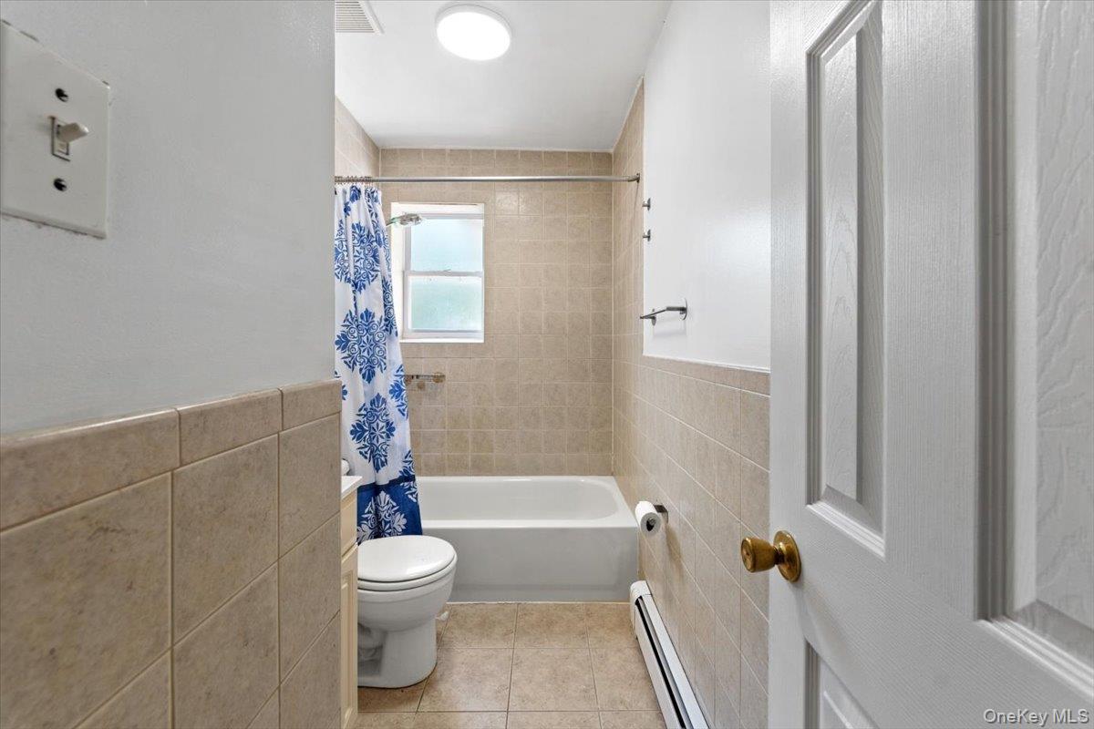 1309 Vreeland Avenue, Unit 2 Bronx, NY 10461 - Photo 9 of 13 a bathroom with a toilet and a shower