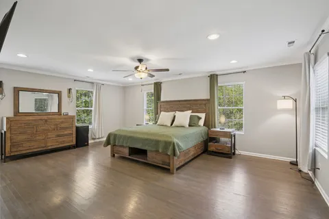 a bedroom with a bed and ceiling fan
